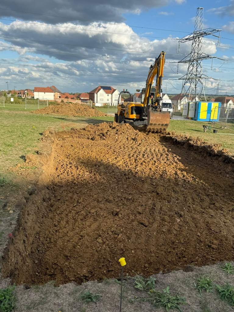 Excavator cutting the reduced-level dig Cambridge