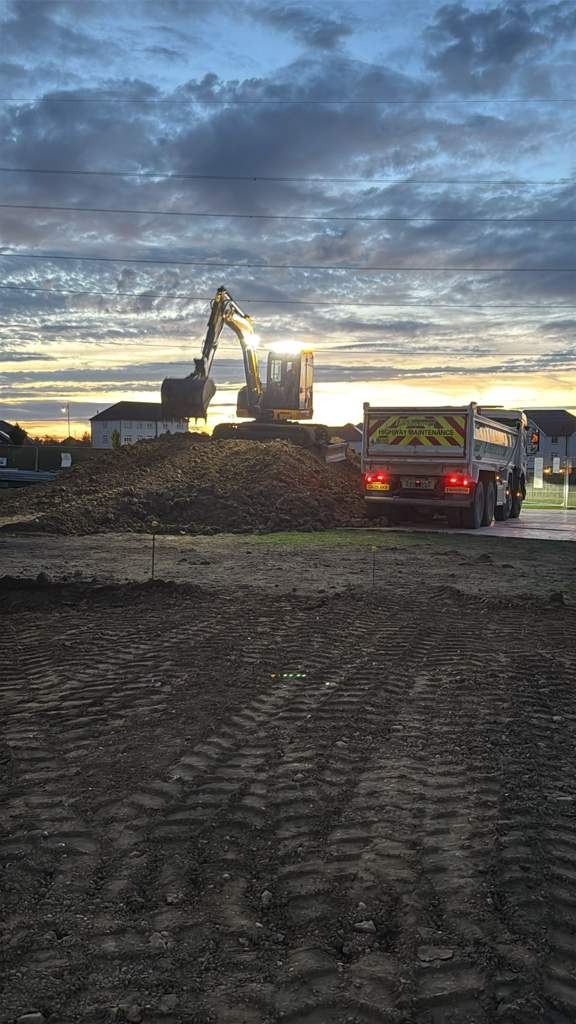 Evening muck-away with excavator loading the eight-wheeler Cambridge