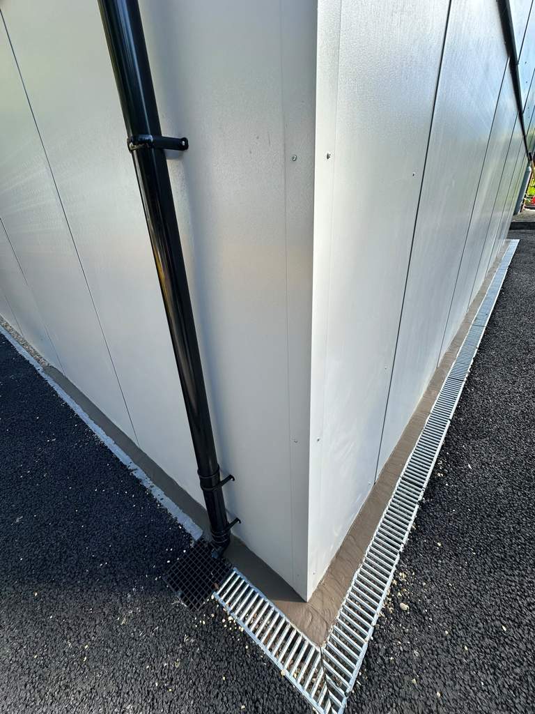 New surface water drainage channel and downpipe connection Ebbsfleet