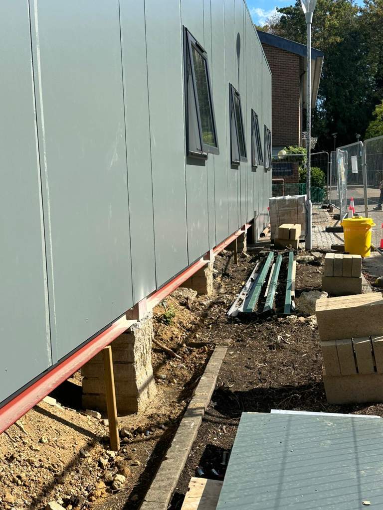 Modular building supported on engineering brick piers during foundation works Ebbsfleet