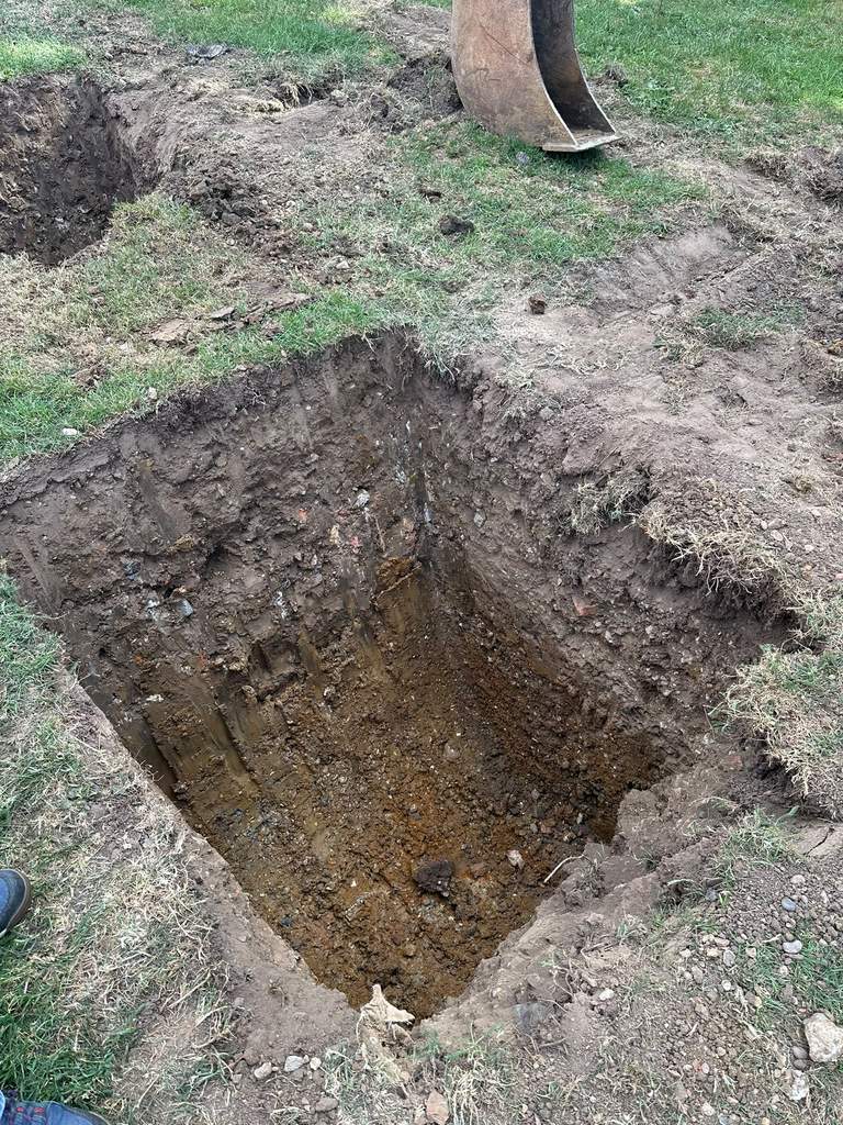 Cleanly excavated square foundation pad with crisp vertical sides