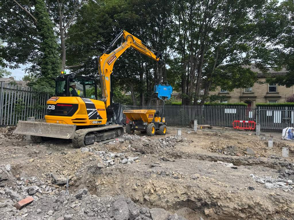 JCB excavator and piling rig preparing piled foundations at Mirfield West Yorkshire