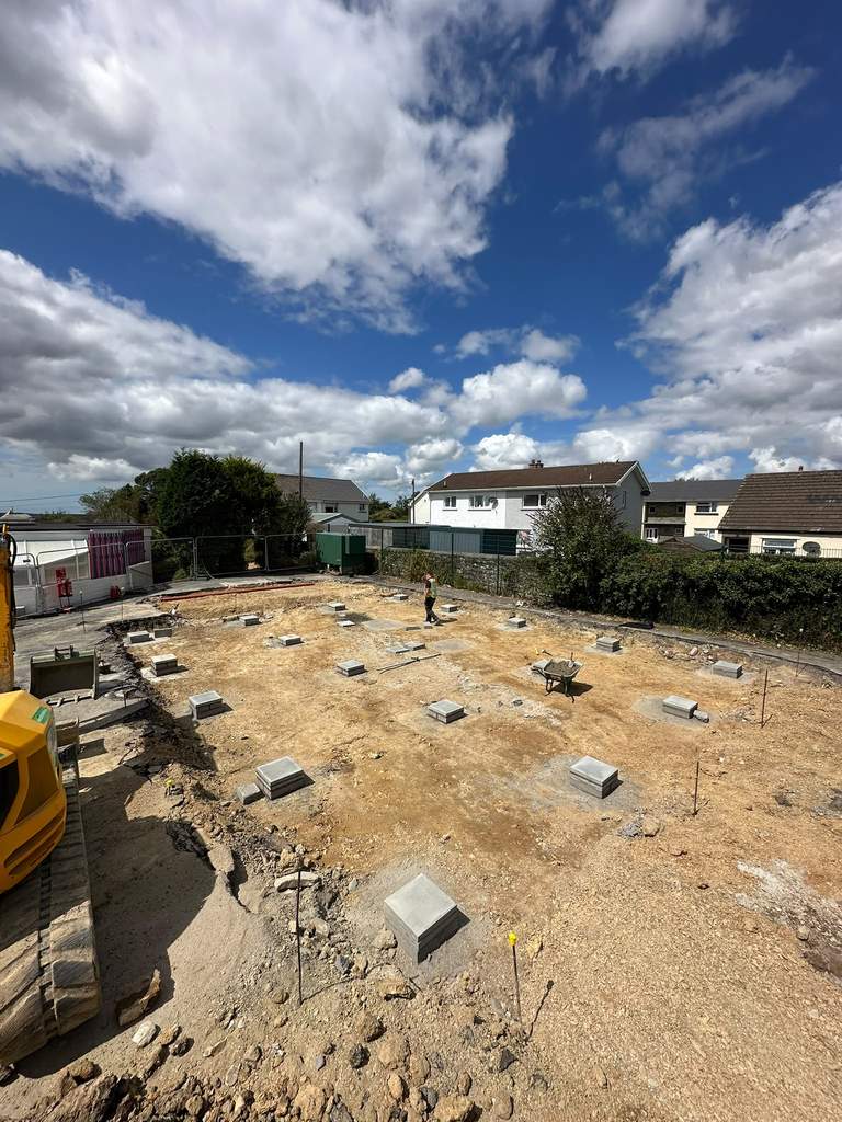 Pad foundations laid out across prepared site under blue skies