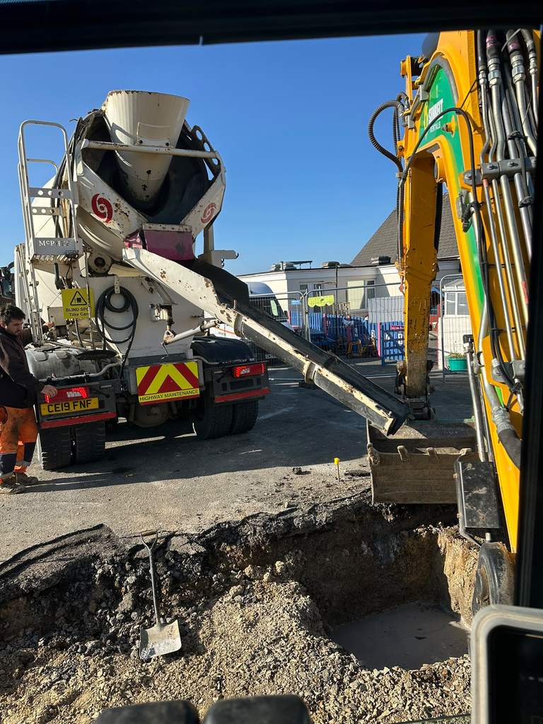 Concrete mixer discharging for pad foundation pours