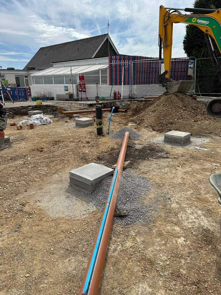 New drainage and water supply runs beside concrete pads