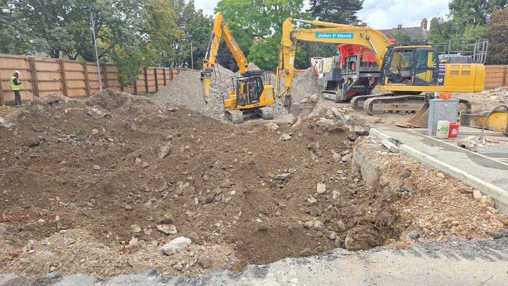 JCB 140X loading the crusher between crushed stone stockpiles