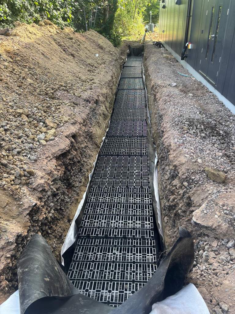 Geocellular soakaway crates laid in drainage trench