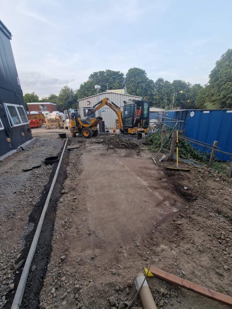 Excavator and dumper finishing prepared sub-base with edgings