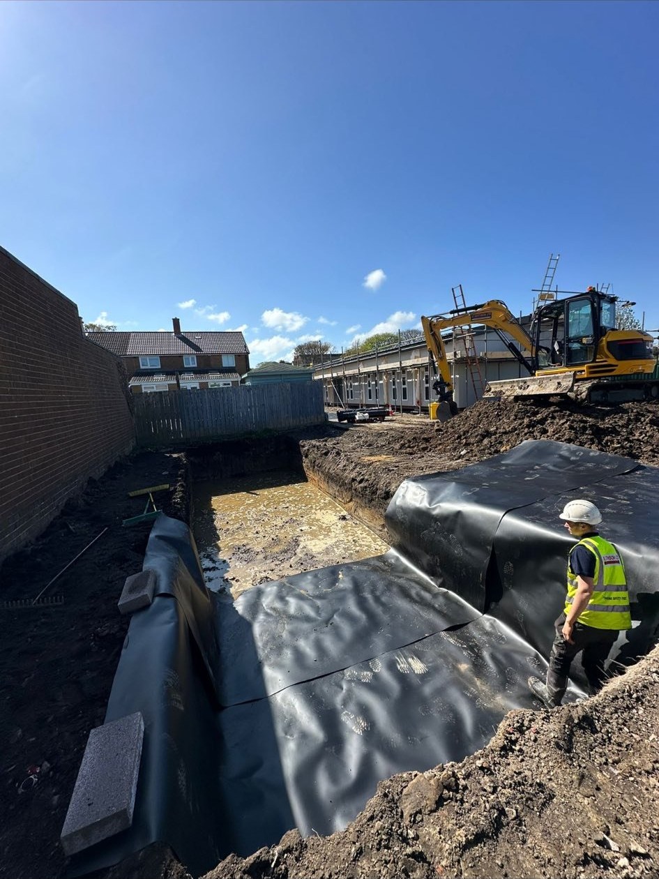 M.Smithson branded dumper and excavator on stripped groundworks site