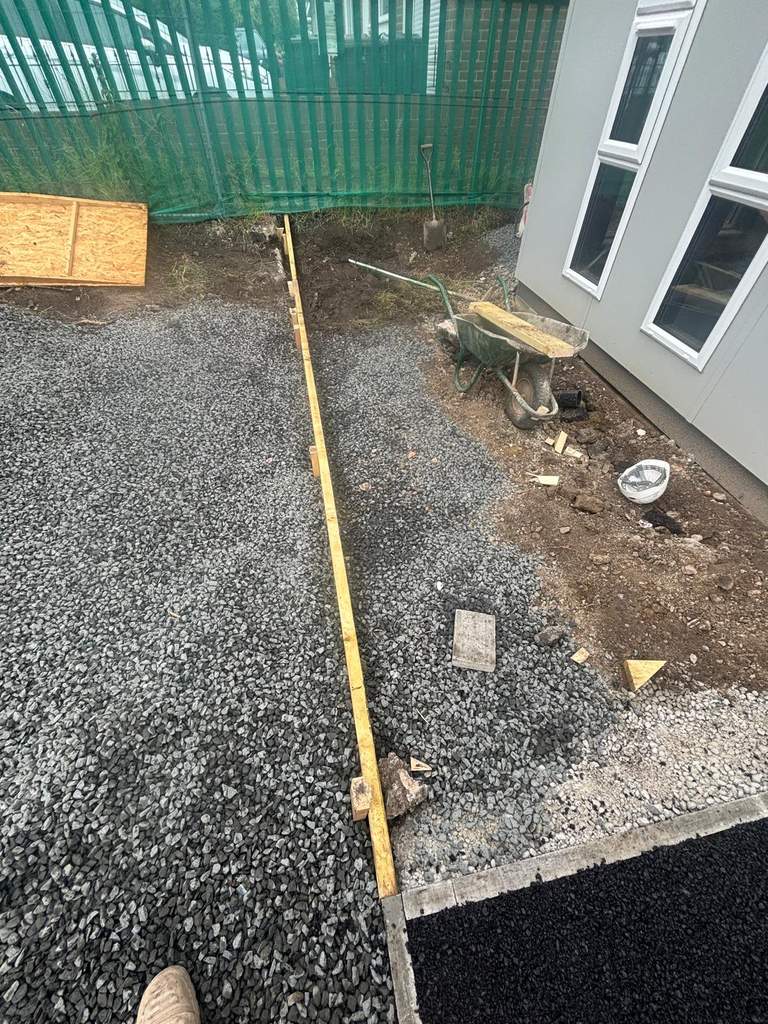 Timber formwork and levelled clean stone ready for surfacing