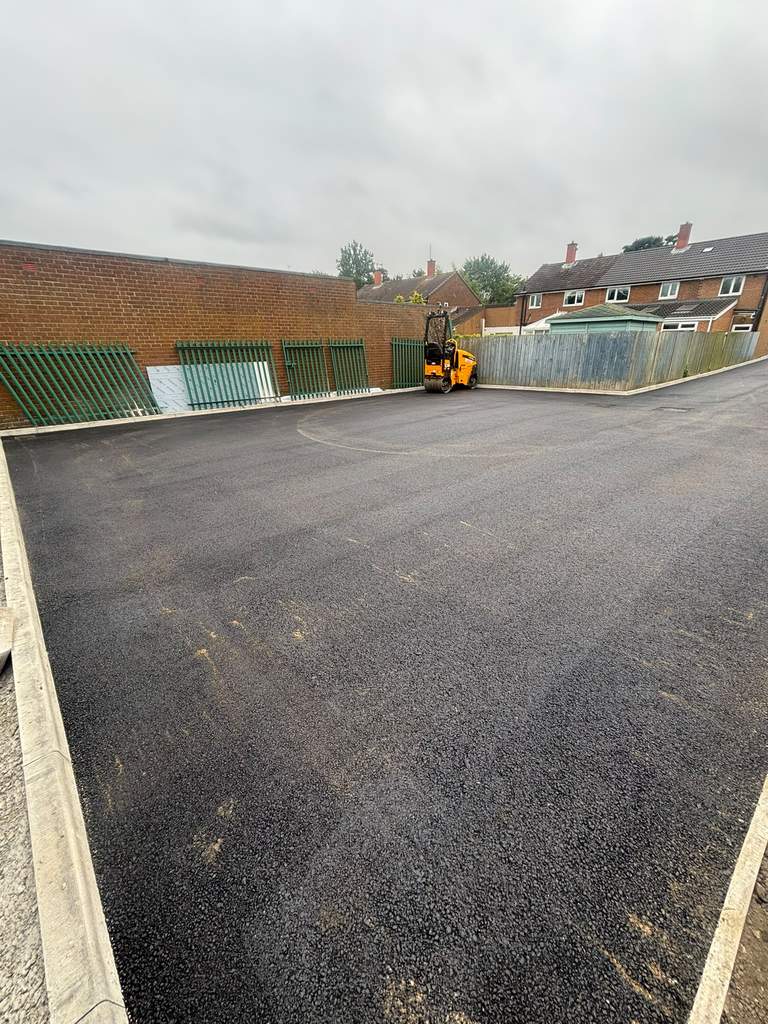 Completed tarmac car park with fresh kerbs